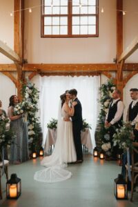 A Rustic Romance Unveiled: Emily and Zack's North Fork Wedding 1 Emily's and Zack's ceremony and kiss