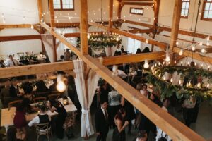 A Rustic Romance Unveiled: Emily and Zack's North Fork Wedding 2 View from the loft of Emily and Zack's reception in the barn at Jedediah Hawkins Inn